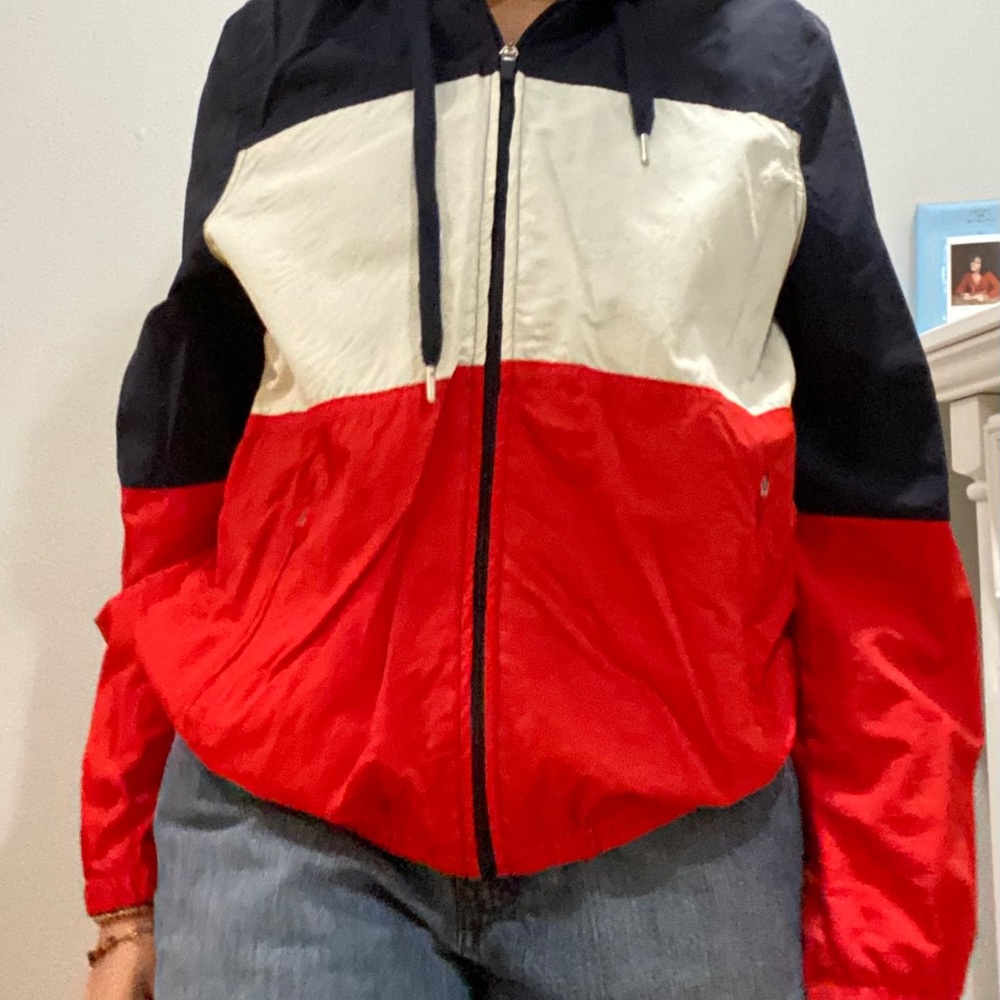 red, navy, and white windbreaker